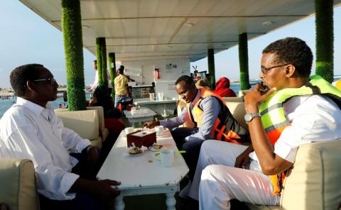 Passengers sit on the lower deck onboard of the luxury La Lanterna Bar restaurant boat, sailing in the Indian Ocean near Lido beach in Mogadishu, Somalia, May 1, 2019. PHOTO BY REUTERS/Feisal Omar