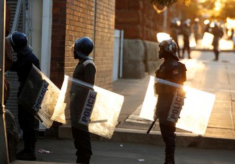 Riot police officers keep watch outside the Tredgold Building Magistrate court in Bulawayo, Zimbabwe, August 19, 2019. PHOTO BY REUTERS/Philimon Bulawayo