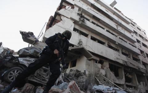 A riot policeman stands outside the building of the Directorate of Security after an explosion in Egypt's Nile Delta town of Dakahlyia, about 120 km (75 miles) northeast of Cairo