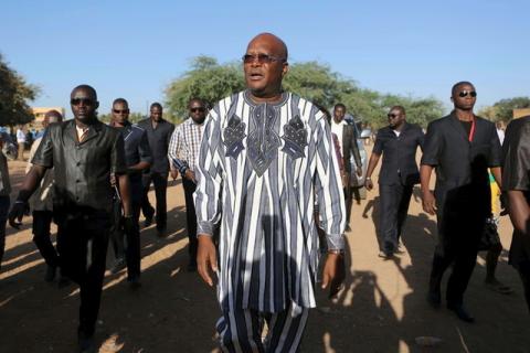 Presidential candidate Roch Marc Kabore (C) arrives to vote during the presidential and legislative election at a polling station in Ouagadougou, Burkina Faso, November 29, 2015. PHOTO BY REUTERS/Joe Penney