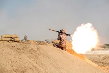 A member of military units of Iran's Islamic Revolutionary Guard Corps fires a rocket launcher as they launched war games in the Gulf, December 22, 2018. PHOTO BY REUTERS/Hamed Malekpour/Tasnim News Agency