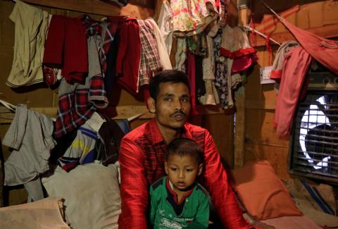 Sahidullah, a man from the Rohingya community, holds his son on his lap as he speaks with Reuters inside his shack at a camp on the outskirts of Jammu, October 5, 2018. PHOTO BY REUTERS/Mukesh Gupta