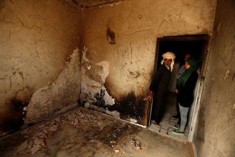 People inspect a burnt room inside their house, which was damaged by fighting between Islamic State jihadists and government forces in Ben Guerdane, near the Libyan border, Tunisia, April 12, 2016. PHOTO BY REUTERS/Zohra Bensemra