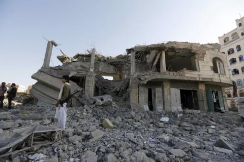 A Houthi militant stands guard outside the house of court judge Yahya Rubaid after a Saudi-led air strike destroyed it, killing him, his wife and five other family members, in Yemen's capital Sanaa, January 25, 2016. PHOTO BY REUTERS/Khaled Abdullah