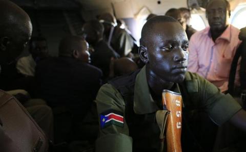 A South Sudan army soldier sweats as he holds his weapon during a flight from the capital Juba to Bor town, 180 km (108 miles) northwest from capital