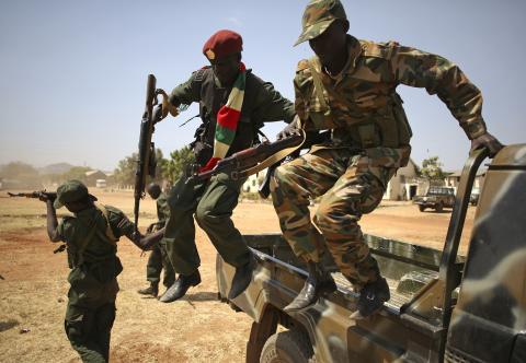 SPLA soldiers jump from a vehicle in Juba