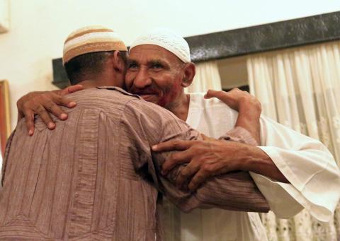 Opposition leader of Umma Party and Sudan's former Prime Minister Sadiq al-Mahdi receives a hug from a supporter at his home in Omdurman after he was released