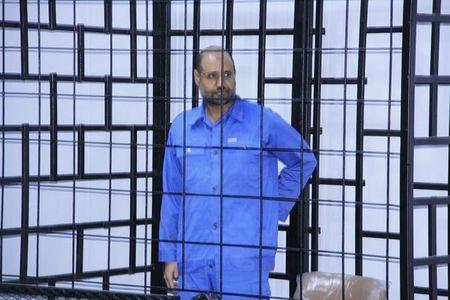 Saif al-Islam Gaddafi, son of late Libyan leader Muammar Gaddafi, attends a hearing behind bars in a courtroom in Zintan, June 22, 2014. PHOTO BY REUTERS/Stringer