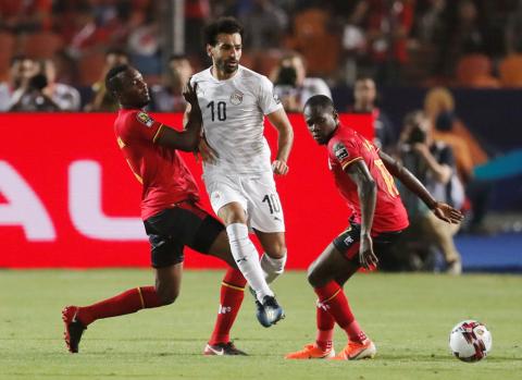 Egypt's Mohamed Salah in action with Uganda's Faruku Miya. PHOTO BY REUTERS/Amr Abdallah Dalsh