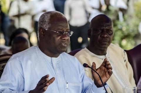 Sam 'Bode' Gibson, the new mayor of Freetown, listens as Sierra Leone's President Ernest Bai Koroma in Freetown