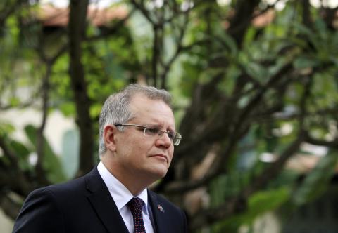 Australia's Immigration Minister Scott Morrison smiles during an interview with Reuters in Phnom Penh