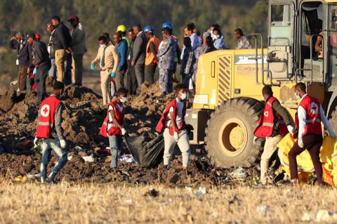 Members of the search and rescue mission carry dead bodies at the scene of the Ethiopian Airlines Flight ET 302 plane crash, near the town of Bishoftu, southeast of Addis Ababa, Ethiopia, March 10, 2019. PHOTO BY REUTERS/Tiksa Negeri