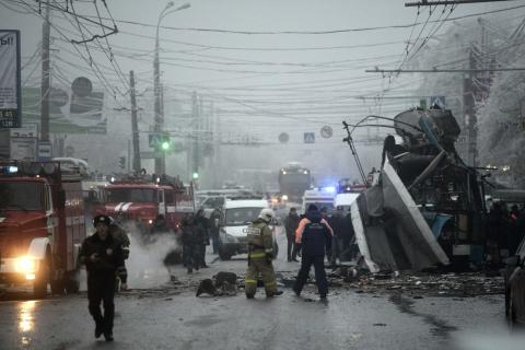 Members of the emergency services work at the site of a bomb blast on a trolleybus in Volgograd