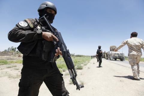 Members of the Iraqi security forces take their positions during an intensive security deployment west of Baghdad