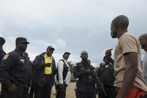 Members of Liberian security forces talk with a protester after clashes at West Point neighbourhood in Monrovia August 20, 2014. PHOTO BY REUTERS/2Tango