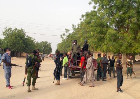 Local volunteers carrying weapons stand in the Jiddari Polo area in the northeastern city of Maiduguri, after an attack by Boko Haram militants, in Nigeria, April 27, 2018. PHOTO BY REUTERS/Ola Lanre