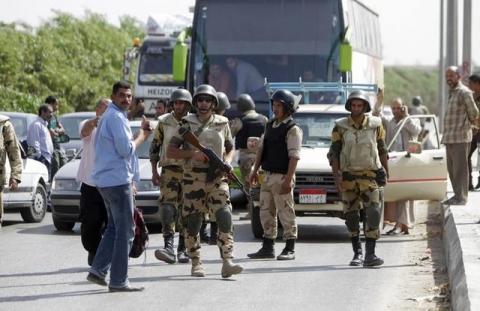 Security forces set up a checkpoint along a road towards Kerdasa, a town 14 km (9 miles) from Cairo. PHOTO  BY REUTERS