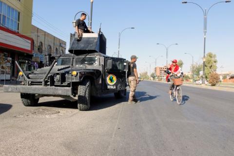 A cyclist gestures at Iraqi security forces, on a street of Kirkuk, Iraq, October 19, 2017. PHOTO BY REUTERS/Ako Rasheed