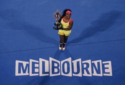 Serena Williams poses with her trophy after defeating Maria Sharapova of Russia in their women's singles final match at the Australian Open 2015 tennis tournament in Melbourne, January 31, 2015. PHOTO BY REUTERS/Carlos Barria