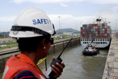 A worker talks on a walkie talkie as cargo ship navigates through locks of the Panama Canal expansion project on the outskirts of Panama City, Panama, June 23, 2016. PHOTO BY REUTERS/Carlos Jasso