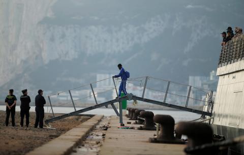 A migrant leaves the Spanish military ship 'Audaz' after arriving from an Italian port, following a prolonged standoff between Italian authorities and Spanish-registered private rescue boat 'Open Arms', at a port in San Roque, near Algeciras, Spain, August 30, 2019. PHOTO BY REUTERS/Jon Nazca