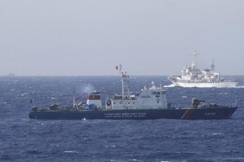 A ship (top) of the Chinese Coast Guard is seen near a ship of the Vietnam Marine Guard in the South China Sea, about 210 km (130 miles) off the shore of Vietnam, May 14, 2014. PHOTO BY REUTERS/Nguyen Minh