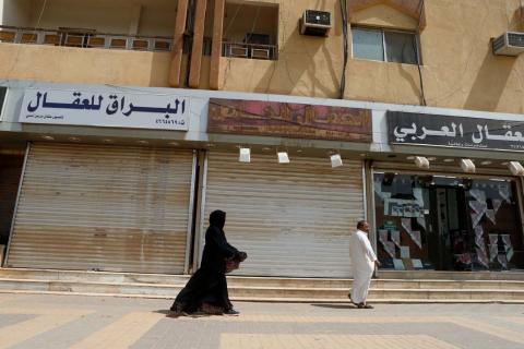 A saudi woman walks next to closed shops in Riyadh, Saudi Arabia, July 12, 2018. PHOTO BY REUTERS/Faisal Al Nasser