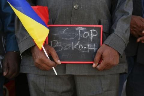 A man holds a sign that reads "Stop Boko Haram" at a rally to support Chadian troops heading to Cameroon to fight Boko Haram, in N'djamena, January 17, 2015. PHOTO BY REUTERS/Emmanuel Braun