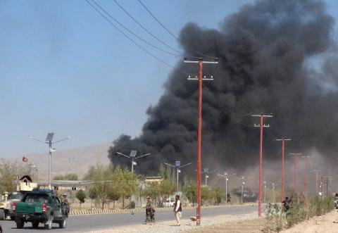 Smoke rises from police headquarters while Afghan security forces keep watch after a suicide car bomber and gunmen attacked the provincial police headquarters in Gardez, the capital of Paktia province, Afghanistan, October 17, 2017. PHOTO BY REUTERS/Stringer