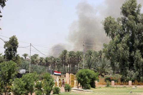 Smoke rises during clashes between the predominantly Sunni militants from the radical Islamic State of Iraq and the Levant (ISIL) and Iraqi security forces in the town of Dalli Abbas in Diyala province