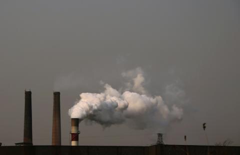 Smoke rises from a chimneys of a steel mill on a hazy day in Fengnan district of Tangshan, Hebei province, February 18, 2014. PHOTO BY REUTERS/Petar Kujundzic