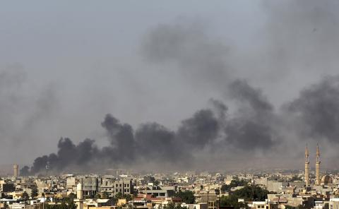 Black plumes of smoke is seen in the vicinity of Camp Thunderbolt, after clashes between militants, former rebel fighters and government forces in Benghazi