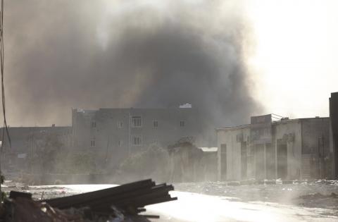 Smoke rises after rockets fired by one of Libya's militias struck and ignited a building after clashes between rival militias, in an area at Alswani road in Tripoli