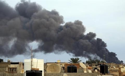 Smoke billows from a factory after an airstrike by forces loyal to former general Khalifa Haftar, in Benghazi, October 22, 2014. PHOTO BY REUTERS/Stringer