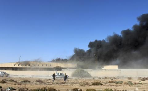 Black smoke billows from a warehouse after an airstrike in Zawura, December 2, 2014. PHOTO BY REUTERS/Stringer