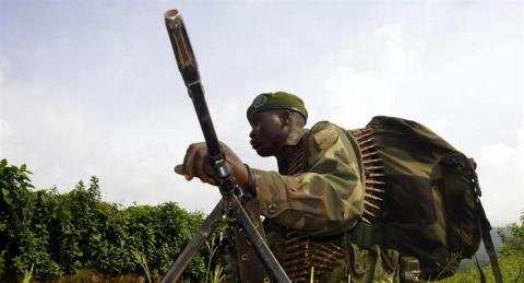 A Congolese soldier holds a position against the M23 rebels near Bunagana, north of Goma