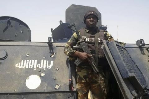 A Cameroonian soldier stands on a Nigerian armoured vehicle used by Boko Haram insurgents to attack a Cameroon army patrol near Waza, February 17, 2015. PHOTO BY REUTERS/Bate Felix Tabi Tabe