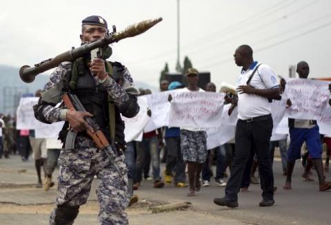 A Burundian soldier walks infront of residents during a demonstration against the Rwandan government in Burundi's capital Bujumbura, February 20, 2016. PHOTO BY REUTERS/Evrard Ngendakumana