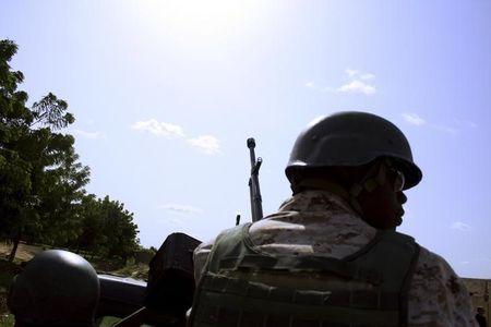 A soldier from Niger escorts U.S. soldiers back to their base following an anti-Boko Haram summit in Diffa city, Niger September 3, 2015. PHOTO BY REUTERS/USA-NIGER/BOKO HARAM