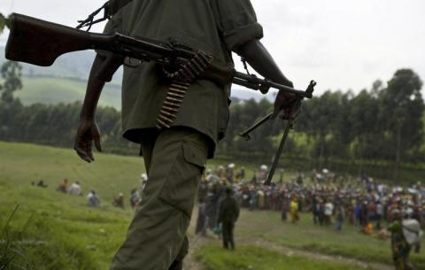 A Democratic Forces for the Liberation of Rwanda (FDLR) soldier walks toward a distribution center near Lushubere Camp in Masisi, km ( miles) northwest of Goma