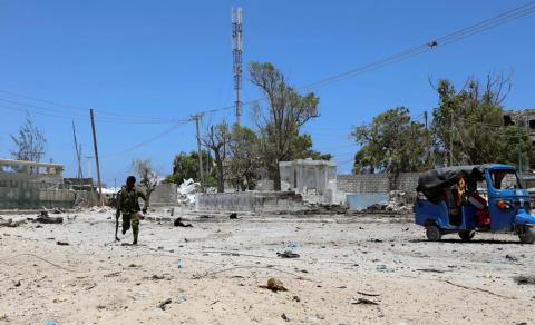  Somali soldier runs to hold position as al-Shabaab militia storms a government building in Mogadishu. PHOTO BY REUTERS/Feisal Omar