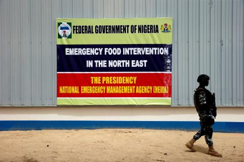 A soldier walks past a banner pasted on a warehouse where food and relief materials for the internal displaced persons are stored on the outskirts of Nigerian city of Maiduguri, Nigeria, June 8, 2017. PHOTO BY REUTERS/Akintunde Akinleye