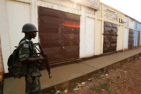 A Democratic Republic of Congo soldier from the African peacekeeping forces stands near closed shops in Bangui, February 20, 2014. PHOTO BY REUTERS/Luc Gnago