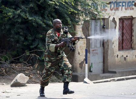 A soldier fires an AK-47 rifle during a protest against President Pierre Nkurunziza and his bid for a third term, in Bujumbura, Burundi, May 25, 2015. PHOTO BY REUTERS/Goran Tomasevic