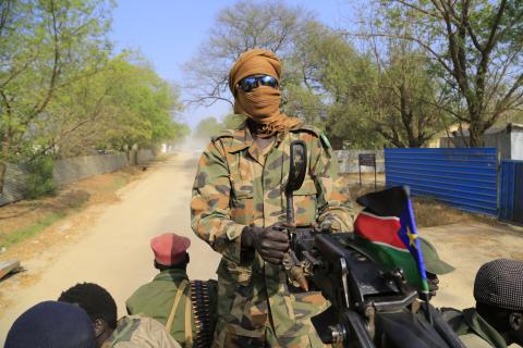 A South Sudan army soldier mans a machine gun, that has been mounted onto a truck, as it drives through a street in Malakal town, 497 km (308 miles) northeast of capital Juba