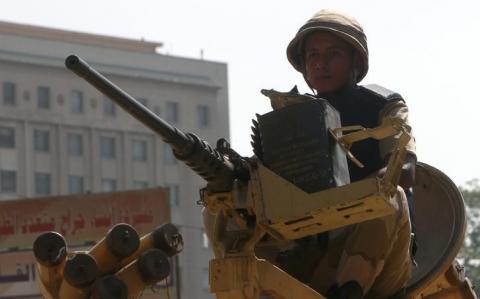 An Egyptian army soldier guards with an armoured personnel carrier (APC) near Tahrir Square in Cairo, August 19, 2013. PHOTO BY REUTERS/Mohamed Abd El Ghany