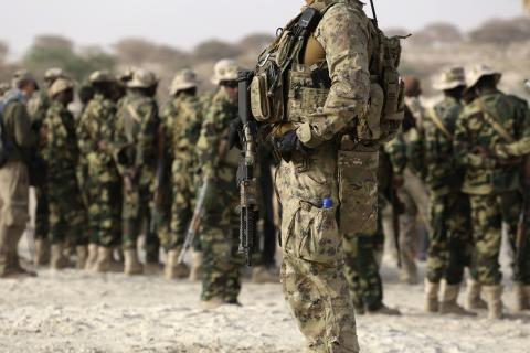 A U.S. special forces soldier stands in front of Chadian soldiers during Flintlock 2015, an American-led military exercise, in Mao, February 22, 2015. PHOTO BY REUTERS/Emmanuel Braun