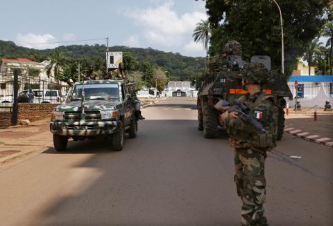 Seleka soldiers drive past French soldiers on patrol in Bangui