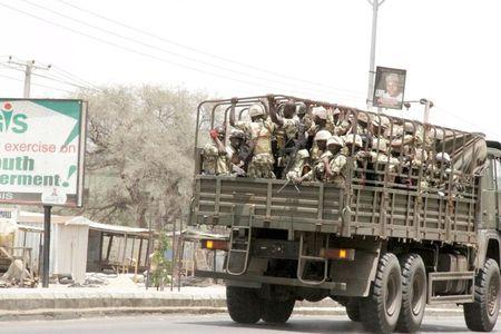 Soldiers are seen on a truck on the road in Maiduguri in Borno State, Nigeria May 14, 2015. REUTERS/Stringer