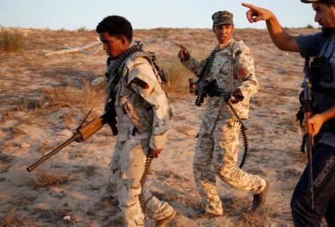 Fighters of Libyan forces allied with the U.N.-backed government walk during reconnaissance patrol in a coastline of Sirte, Libya, July 25, 2016. PHOTO BY REUTERS/Goran Tomasevic